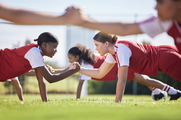 Women soccer, football or team sports holding hands in unity, support or motivation in routine work